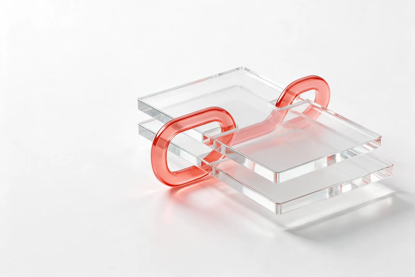 Two stacked clear glass sheets held together by a coral-red glass chain link: a new version replaces the old one and the link stays the same.